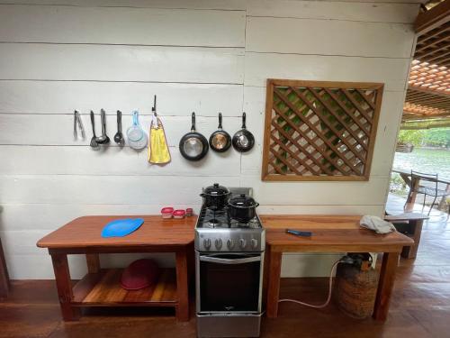 a kitchen area with a table, stove, and a stove top oven at Finca Tatin in Lámpara
