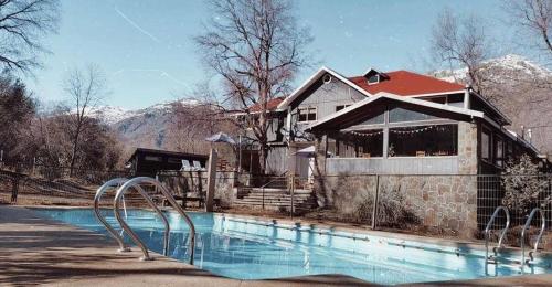 a house with a swimming pool in front of a house at HOTEL BOUTIQUE ANTTUY - Snow Spa in Chillán