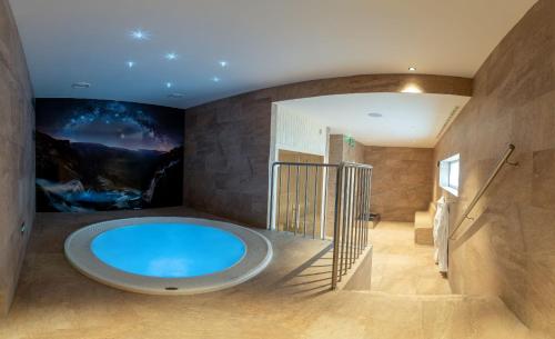 un ampio bagno con una grande vasca blu di Resort Vrchlabí a Vrchlabí