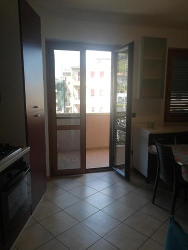 a view of a kitchen with a sliding glass door at Appartamenti Scilla Paese Albergo in Scilla