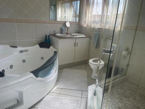 a bathroom with a bath tub and a toilet at Trevi Sea-view Apartment in Margate