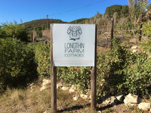a sign for a farm in a field at Long Thin Farm in Stilbaai