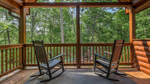 two chairs sitting on the porch of a cabin at Aska Retreat in Blue Ridge