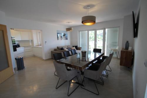 a dining room and living room with a table and chairs at Four bedroom Beach House Amaya Medulin in Medulin