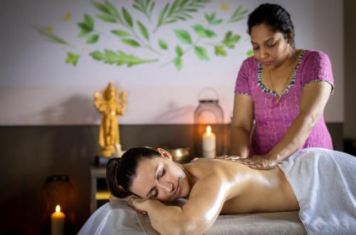 a woman getting a massage from a therapist at JUFA Hotel Stift Gurk in Gurk