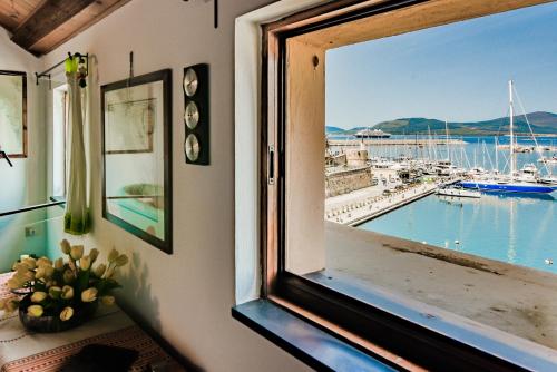 a window with a view of a marina at Vista Porto in Alghero