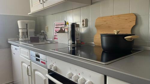 a kitchen with a counter top with a stove top at Ferienwohnung Weitsicht in Hüttenrode