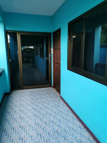 an empty room with a door and a tiled floor at Bankaina in Hua Hin