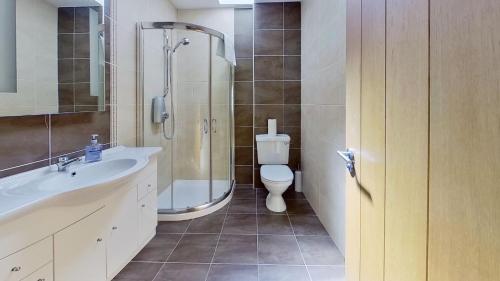 a bathroom with a shower and a sink and a toilet at Harbour View, Mullaghmore, Sligo in Sligo