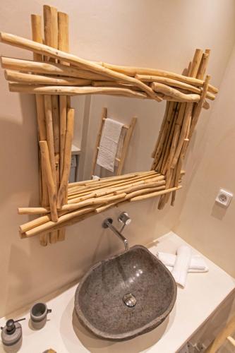 a bathroom with a stone sink and a mirror at Juliano luxury apartments, port of Naxos in Naxos Chora