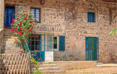 a stone building with a green door and flowers at 2 Bedroom Nice Home In Trambly in Trambly