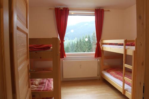 a room with two bunk beds and a window at Cozy apartment in Bedřichov - Špindlerův Mlýn in Špindlerův Mlýn