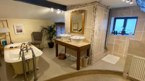 a bathroom with two sinks and a mirror at The Old Thatch - Hennock in Newton Abbot