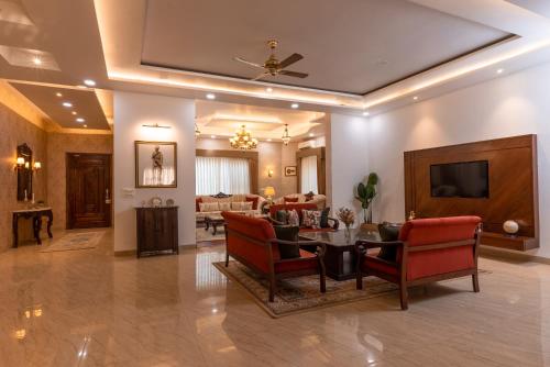 a living room with a table and chairs and a television at Kunwar Villa in Amritsar