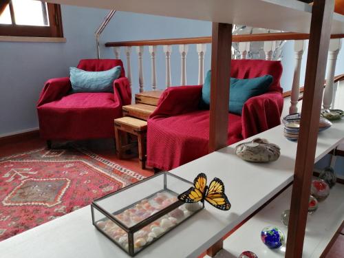 a living room with a table with a butterfly on it at Peniche Blue Wave Home in Peniche
