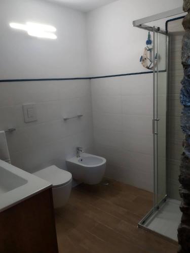 a bathroom with a toilet and a sink and a shower at Elios bed and breakfast in Villa - Fuscaldo in Pietrapiana