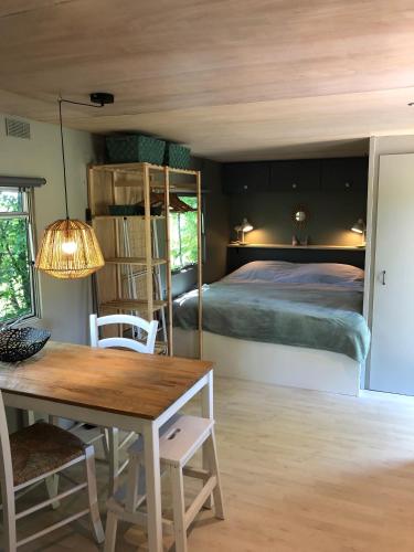 une chambre avec un lit et une table et une salle à manger dans l'établissement Un bel endroit dans la nature, à Beyssac