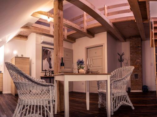 a dining room with a table and two chairs at Csoda Szarvas Birtok in Szarvas