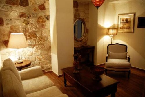 a living room with a couch and a chair at Korina Gallery Hotel in Vathi, Ithaka