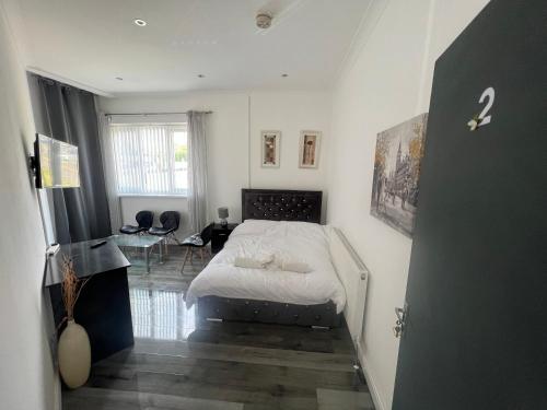 a bedroom with a bed and a room with a table at Zams rooms in Stoke on Trent