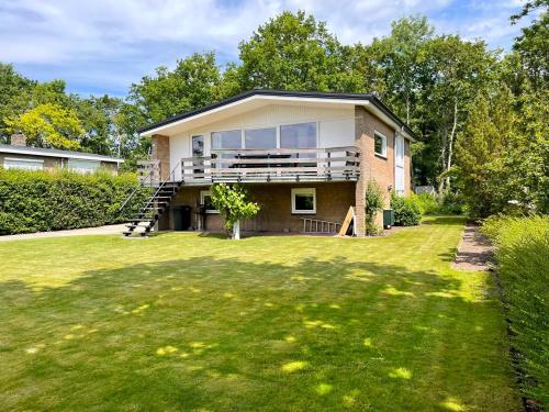 a house with a large lawn in front of it at Holidayhouse De Schotsman in Kamperland