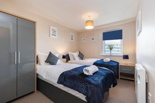a bedroom with two beds and a window at Oakstays Gateshead in Gateshead