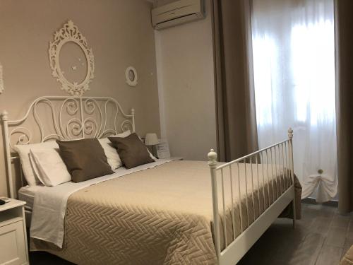 a bedroom with a white bed and a window at Golden Mile B&B in Ercolano
