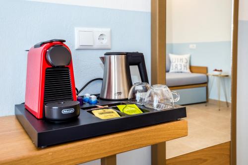 a counter with a coffee maker and a blender on it at Alia Comfort Style Studios in Limenaria