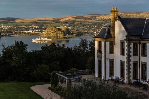 a house with a view of a body of water at Gleddoch Golf & Spa Resort in Langbank