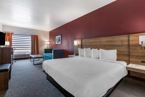 a hotel room with a large bed and a desk at Best Western Plus Casa Grande Inn & Suites in Casa Grande