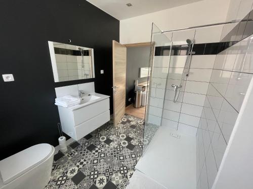 a bathroom with a toilet and a glass shower at Room of Tournai 3 in Tournai