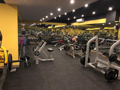 a gym filled with lots of bikes and machines at Jasmine Court Hotel & Casino in Kérynia