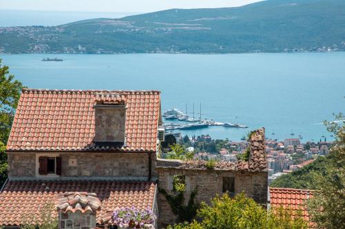 a view of a large body of water with buildings at Old Stone House Villas in Tivat