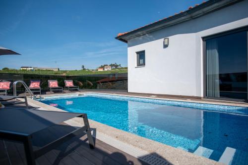 a swimming pool in front of a house at Casa Dona Maria - Armamar Douro in Armamar