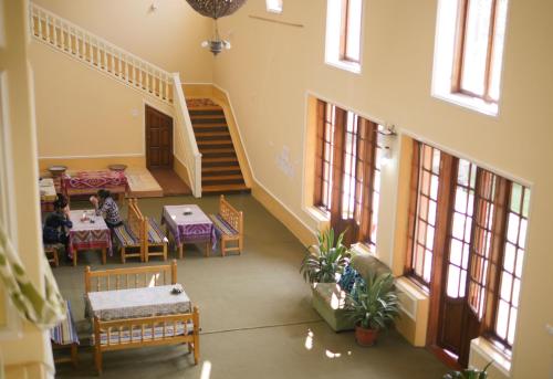 an overhead view of a room with a table and a staircase at Guest House Ikathouse in Margilan