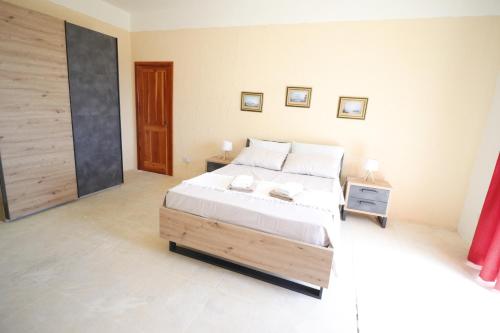 a bedroom with a large bed with white sheets at Villa Serenity B&B in Sannat