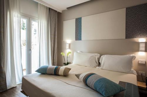 a bedroom with a large bed with two pillows on it at NOHA Lifestyle Hotel - Adults Only in Pula