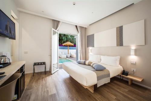 a bedroom with a bed and a desk and a window at NOHA Lifestyle Hotel - Adults Only in Pula