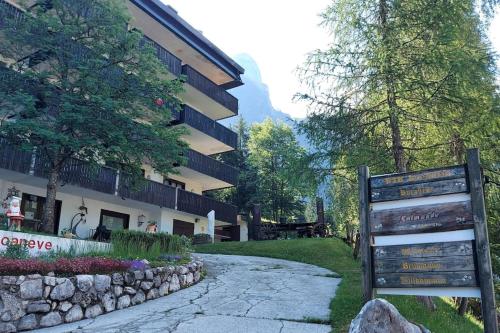 a sign in front of a building at Appartamento incantevole con ampio balcone in Sella Nevea