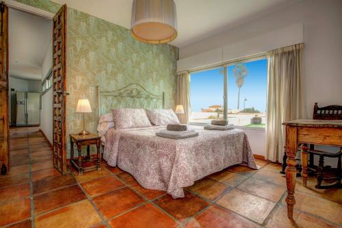 a bedroom with a bed and a large window at Villa La Cala Playa by Villa Plus in La Cala de Mijas