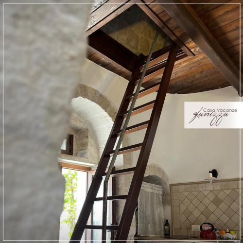 a wooden ladder in a kitchen with a ceiling at Trullo Eliana in Alberobello