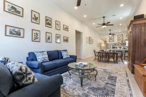a living room with a blue couch and a table at Renovated Historic 4BR House Near Magazine St & Uptown in New Orleans
