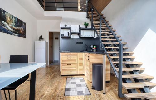 a kitchen with a spiral staircase in a loft at ZenLoft Apartman in Eger