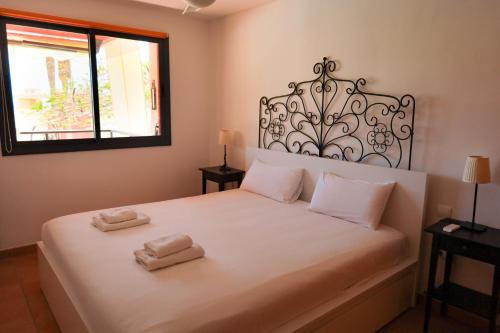 um quarto com uma cama branca com duas toalhas em Best duplex FREE WIFI em Playa Paraiso