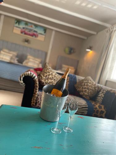 a bottle of champagne in a bucket on a table with two glasses at Molesworth Arms in Wadebridge