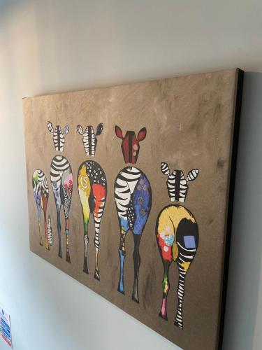 a painting of zebras on a wall at Molesworth Arms in Wadebridge
