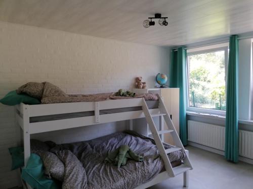 a white bunk bed in a room with a window at Rent & Relax in Mol