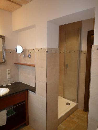 a bathroom with a shower and a sink and a tub at Gästehaus Johanna in Bad Wiessee