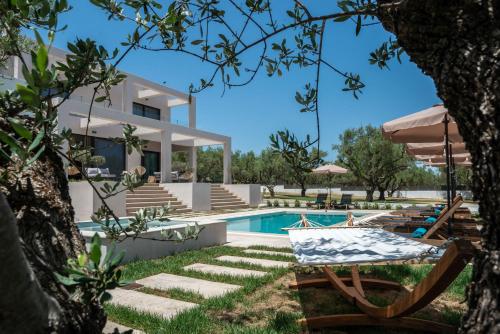 a villa with a swimming pool and a house at Delight Luxury Villa in Zakynthos