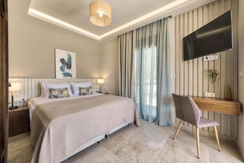 a bedroom with a bed and a desk and a tv at Delight Luxury Villa in Zakynthos Town